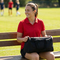 Custom women's sports polo shirts with club badges, available in multiple colours