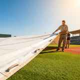 Green heavy-duty baseball field tarp with reinforced edges and handles