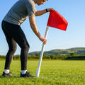 Corner flag poles with ground sleeves for sports pitches