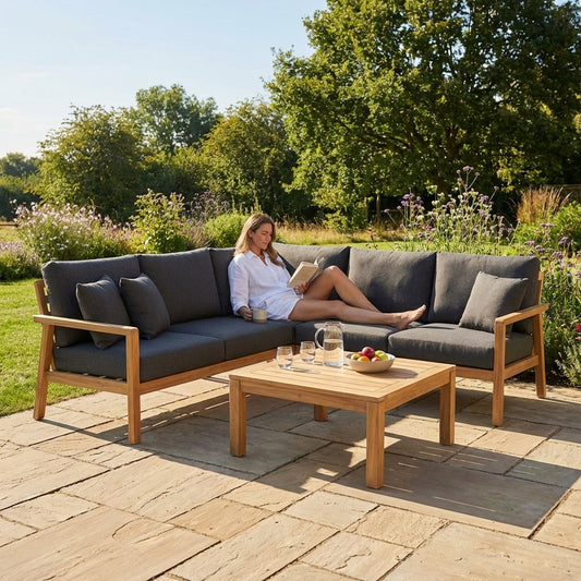 Garden corner sofa set with charcoal cushions and teak table