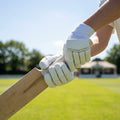Junior cricket batting gloves with leather palm and mesh ventilation