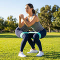 Fabric resistance bands in green, pink, and purple for gym and home workouts