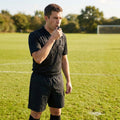 Black sports whistle with lanyard for school and club use