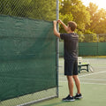 Green Tennis Court Windbreaks on an outdoor tennis court