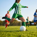 Women's football kit with long-sleeved striped shirt, shorts, and knee-high socks
