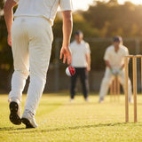 Cricket training ball with reverse swing capability, in red/white and pink/white