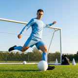 Men's football kit in various colours, including long-sleeve shirt, shorts, and socks