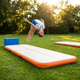 Inflatable gymnastics mat in orange and grey designed for home and gym use
