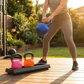 Black kettlebell stand with non-slip tray for gym use