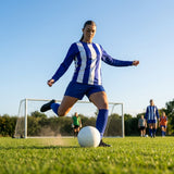 Women's football kit with long-sleeved striped shirt, shorts, and knee-high socks