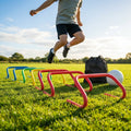 Adjustable foam hurdles in red, yellow, green, and blue for young athletes