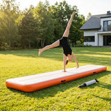 Inflatable gymnastics mat in orange and grey designed for home and gym use