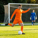 Men's football kit in various colours, including long-sleeve shirt, shorts, and socks