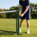 Professional tennis net and posts setup in green