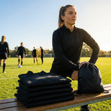 Black quarter-zip top made from lightweight polyester for indoor and outdoor use
