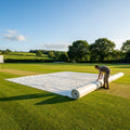 Green heavy-duty baseball field tarp with reinforced edges and handles