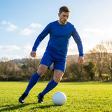 Men's football kit in various colours, including long-sleeve shirt, shorts, and socks
