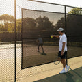 Green Tennis Court Windbreaks on an outdoor tennis court