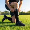 Black shin pads with compression sleeves for football players