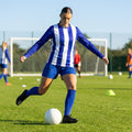 Women's football kit with long-sleeved striped shirt, shorts, and knee-high socks