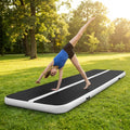 Inflatable gymnastics mat in orange and grey designed for home and gym use