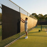 Green Tennis Court Windbreaks on an outdoor tennis court